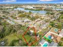 Aerial view of a property surrounded by trees, with a lake and city skyline in the distance at 444 Sunnyview Cir, Orlando, FL 32810