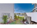 Backyard with a view of a community lake and new construction homes at 4512 Sparkling Shell Ave, Kissimmee, FL 34746