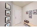 Entryway displaying art decor, neutral walls, a white front door, and a tiled floor at 4512 Sparkling Shell Ave, Kissimmee, FL 34746
