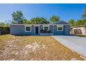 Beautiful one-story home featuring a well-maintained yard, simple landscaping, and a freshly painted gray facade at 5206 Cortez Dr, Orlando, FL 32808