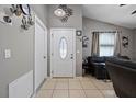 Inviting entryway showcasing neutral paint, tile flooring, decorative wall accents and a front door with oval glass insert at 536 Southern Charm Dr, Orlando, FL 32807