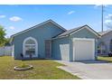 Charming home featuring a garage and well-maintained lawn on a sunny day at 536 Southern Charm Dr, Orlando, FL 32807