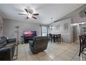 The open living room features tile floors, a ceiling fan, and neutral paint, creating a cozy and inviting space at 536 Southern Charm Dr, Orlando, FL 32807