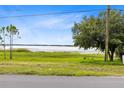 Scenic view showcasing the property's tranquil natural setting, with expansive green space and a serene lake backdrop at 6305 Bass Hwy, St Cloud, FL 34771