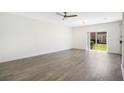 Bright, open living room with sliding glass doors and wood-look flooring at 10124 Shadow Leaf Ct, Orlando, FL 32825
