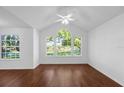Bright bedroom with three large windows offering a scenic view and hardwood floor at 1013 S Hiawassee Rd # 3628, Orlando, FL 32835