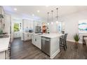 Bright kitchen featuring stainless steel appliances, a central island with pendant lighting, and wood-look tile flooring at 10255 Beechwood Ln, Orlando, FL 32832