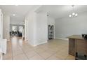 Open entryway with neutral tile floors, seamlessly connecting multiple living spaces at 1158 Oak Bluff Dr, Davenport, FL 33837