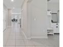 Inviting entryway showcasing neutral tile flooring and convenient built-in storage at 1158 Oak Bluff Dr, Davenport, FL 33837