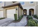 A charming townhome with a private garage and an inviting front entrance at 1284 Pavia Dr, Apopka, FL 32703