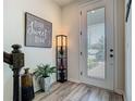 Inviting entryway with stylish decor, wood-look floors, and ample natural light at 14432 Orchid Island Dr, Orlando, FL 32827