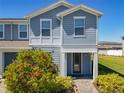 Charming two-story townhome with inviting entrance and manicured landscaping at 14432 Orchid Island Dr, Orlando, FL 32827