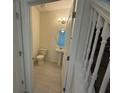 Clean powder room with pedestal sink and soft lighting, conveniently located near staircase at 15872 Moonlight Bay St, Winter Garden, FL 34787