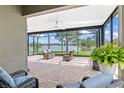 Relaxing screened lanai offers picturesque lake views, comfortable seating, and a brick-paved floor at 1628 Thetford Cir, Orlando, FL 32824