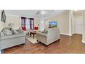 Inviting living room with hardwood floors, neutral walls, and comfortable seating arrangement at 18302 15Th Ave, Orlando, FL 32833