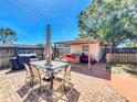 Inviting brick patio with an outdoor seating area, grill, and a storage shed under a clear blue sky at 2342 Linda St, Lake Wales, FL 33898