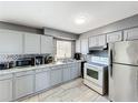 Well-equipped kitchen featuring stainless steel appliances, gray cabinets, and ample counter space at 2342 Linda St, Lake Wales, FL 33898