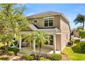 Charming two-story home featuring a welcoming front porch with decorative columns and manicured landscaping at 2531 Seabranch St, Orlando, FL 32828