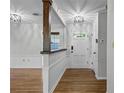 Welcoming foyer featuring hardwood floors, a paneled wall, stylish lighting, and a bright, airy ambiance at 2545 Dellwood Dr, Orlando, FL 32806