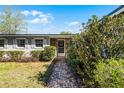 Inviting front entrance with a brick walkway, decorative wreath, and well-maintained landscaping at 2545 Dellwood Dr, Orlando, FL 32806