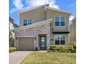 Charming two-story home boasts stone accents, manicured lawn, and a welcoming entrance at 2805 Bookmark Dr, Kissimmee, FL 34746