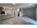 Open-concept living area featuring tile floors and a staircase to the upper level at 2978 Aqua Virgo Loop # 13, Orlando, FL 32837