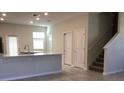 Spacious open-plan room showing living and kitchen areas and a stairway at 2978 Aqua Virgo Loop # 13, Orlando, FL 32837