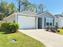 Well-maintained single-story home featuring a one-car garage and neat landscaping at 3437 Possehl Pl, The Villages, FL 32163