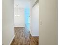 Inviting hallway with wood floors leading to a bright living area at 3437 Possehl Pl, The Villages, FL 32163