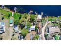 Overhead shot of lake houses with docks and various boats along the shoreline at 36112 Lake Unity Rd, Fruitland Park, FL 34731