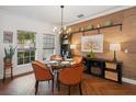 Dining room featuring stylish chairs, wood floors, and bright natural light at 3616 Deer Oak Cir, Oviedo, FL 32766