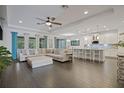 Open-concept living space with modern tile flooring, an island with seating, and a comfortable sectional sofa at 3893 Wind Dancer Cir, St Cloud, FL 34772