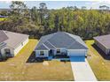 An attractive single Gathering home with a landscaped lawn, and driveway leading to an attached two-car garage at 442 Big Black Pl, Kissimmee, FL 34759