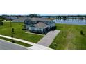 Stunning home with manicured lawn, long driveway, and beautiful lake view providing an ideal setting at 4512 Cutwater Dr, Orlando, FL 32820