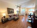 Bright living room features lots of light, wood floors, and vaulted ceilings at 4638 River Ridge Dr, Leesburg, FL 34748
