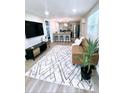 Open concept living room and kitchen with modern gray, black, and stainless steel appliances at 5237 Davisson Ave, Orlando, FL 32810