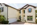 Spacious two-story home with a brick driveway and an attached two-car garage at 6008 Golden Dewdrop Trl, Windermere, FL 34786