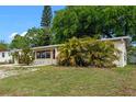 Charming single-story home featuring a red front door and a well-maintained, rock landscaped front yard at 6031 W Ridgewood Ave, Orlando, FL 32835