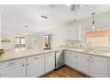 Bright kitchen featuring white cabinetry, sleek countertops, and modern appliances open to dining room at 613 Nuevo Leon Ln, The Villages, FL 32159