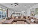 Open-concept living room with modern furnishings and seamless access to outdoor living spaces at 7012 Oakwood St, Davenport, FL 33837