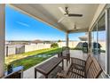 Inviting covered patio with ceiling fans, comfortable seating, and a grill, perfect for outdoor dining and relaxation at 7633 Agrigento St, Clermont, FL 34714