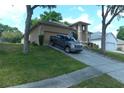 View of house with landscaping, driveway, truck, and a well manicured front lawn at 908 Hilly Bend Dr, Apopka, FL 32712