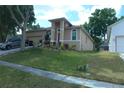 Charming home featuring a landscaped front yard, a two-car garage and a cozy, covered front porch at 908 Hilly Bend Dr, Apopka, FL 32712