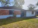 A single-story home with a brick facade and simple landscaping, situated on a grassy lot at 1011 Beulah Dr, Edgewater, FL 32132