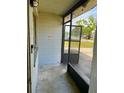 Enclosed front porch featuring a screened door and tile flooring at 1011 Beulah Dr, Edgewater, FL 32132