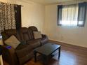 Cozy living room featuring wood floors, a sofa, and a window providing natural light at 1011 Beulah Dr, Edgewater, FL 32132