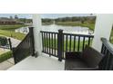 Relaxing porch overlooking a serene pond with a fountain, providing a peaceful outdoor retreat at 1011 Cedar Bay Ln, Winter Springs, FL 32708