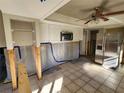 Partially remodeled kitchen featuring stainless steel appliances, white cabinetry, and tile flooring at 1019 Chippewa Trl, Daytona Beach, FL 32117
