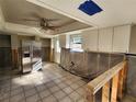 Partially remodeled kitchen featuring stainless steel appliances, white cabinetry, and tile flooring at 1019 Chippewa Trl, Daytona Beach, FL 32117