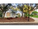Beautiful home exterior with mature landscaping, trees, and a well-maintained lawn at 1213 Brampton Pl, Lake Mary, FL 32746